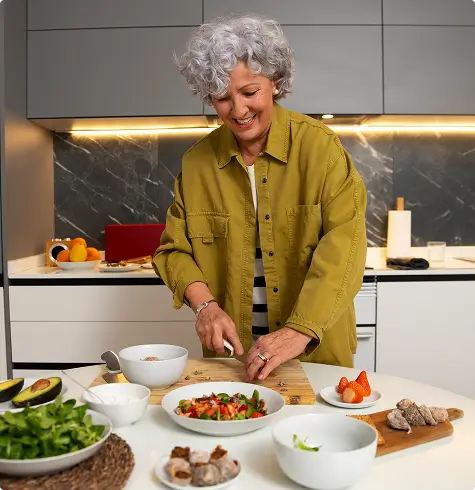 Recovery expectations after EAE procedure: patient returning to normal activities, such as cooking, shortly after minimally invasive elbow treatment.