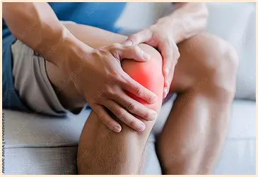 Person experiencing knee pain, illustrating the need for GAE treatment.